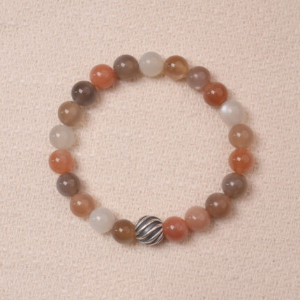 A stunning multicolor Moonstone bracelet with a variety of pastel hues, accented with a silver bead for added elegance. This bracelet combines soothing energy and the healing properties of Moonstone, making it perfect for balance and calm.