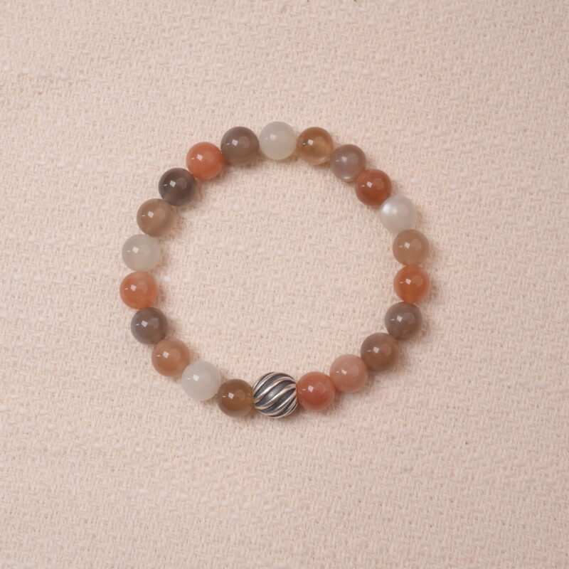 A stunning multicolor Moonstone bracelet with a variety of pastel hues, accented with a silver bead for added elegance. This bracelet combines soothing energy and the healing properties of Moonstone, making it perfect for balance and calm.