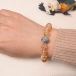 Model wearing citrine and amethyst bracelet, showcasing its warm golden and violet glow.