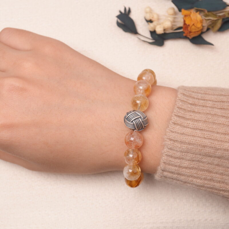 Model wearing citrine and amethyst bracelet, showcasing its warm golden and violet glow.
