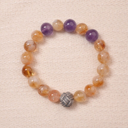Citrine and amethyst bracelet featuring natural golden and purple beads, symbolizing wealth and wisdom.