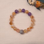 Lifestyle photo of citrine and amethyst bracelet placed on fabric, radiating positivity and clarity.