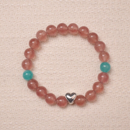 A beautiful Strawberry Quartz bracelet featuring heart-shaped silver accents and Angelite beads, creating a soothing and romantic look. The bracelet combines the healing properties of Strawberry Quartz and Angelite with a delicate silver heart charm.