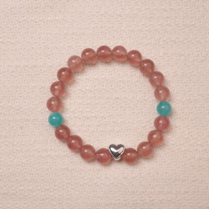 A beautiful Strawberry Quartz bracelet featuring heart-shaped silver accents and Angelite beads, creating a soothing and romantic look. The bracelet combines the healing properties of Strawberry Quartz and Angelite with a delicate silver heart charm.