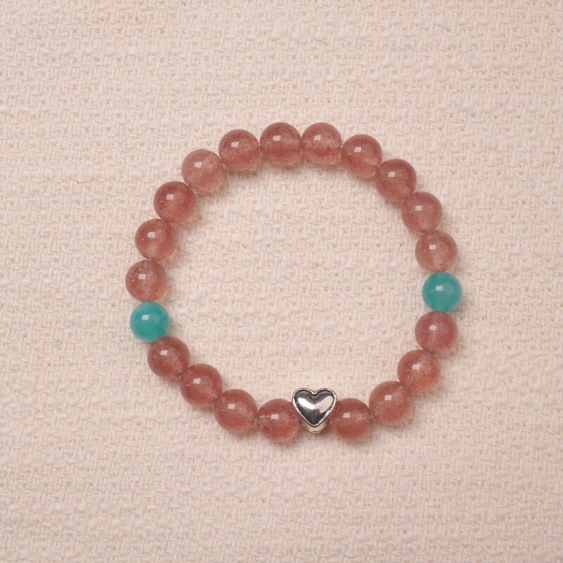 A beautiful Strawberry Quartz bracelet featuring heart-shaped silver accents and Angelite beads, creating a soothing and romantic look. The bracelet combines the healing properties of Strawberry Quartz and Angelite with a delicate silver heart charm.