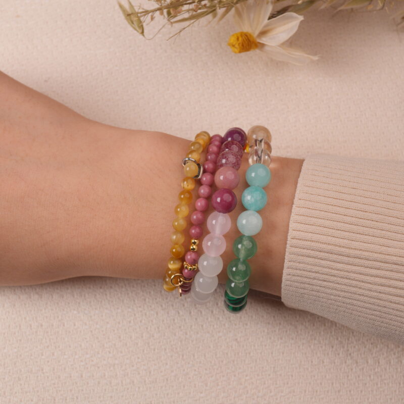 Model wearing the Blossom Heart bracelet stack — a radiant expression of love and tenderness.1