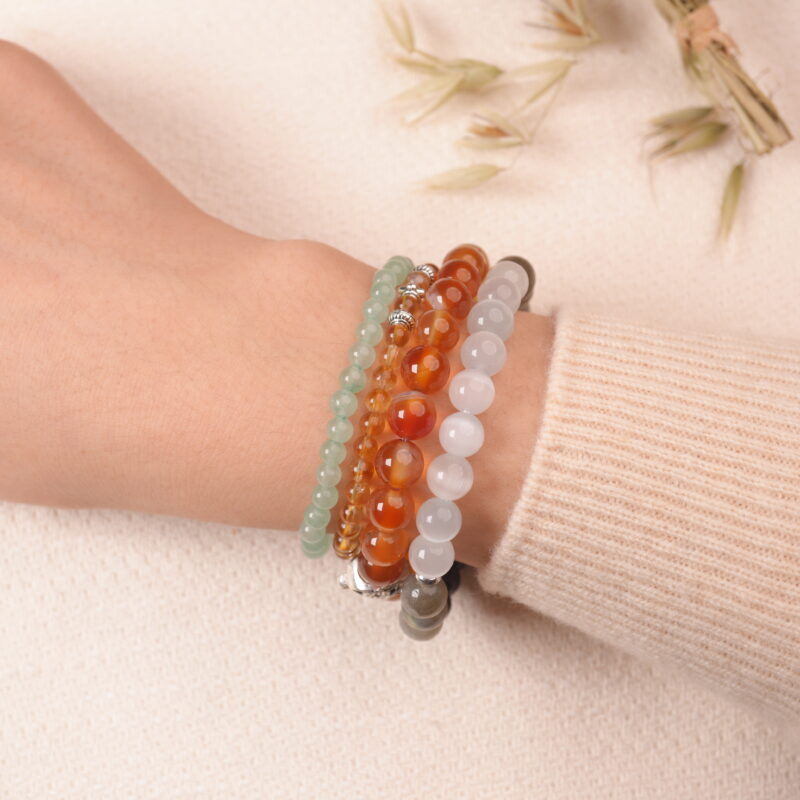 Model wearing the Solar Energy bracelet stack — a radiant accessory for strength and motivation.1