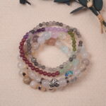 Lifestyle photo of Calm crystal bracelet stack placed on soft fabric, radiating gentle and peaceful energy.