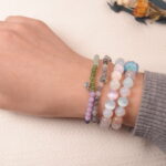 Model wearing the Calm crystal bracelet stack, representing serenity, relaxation, and emotional balance.