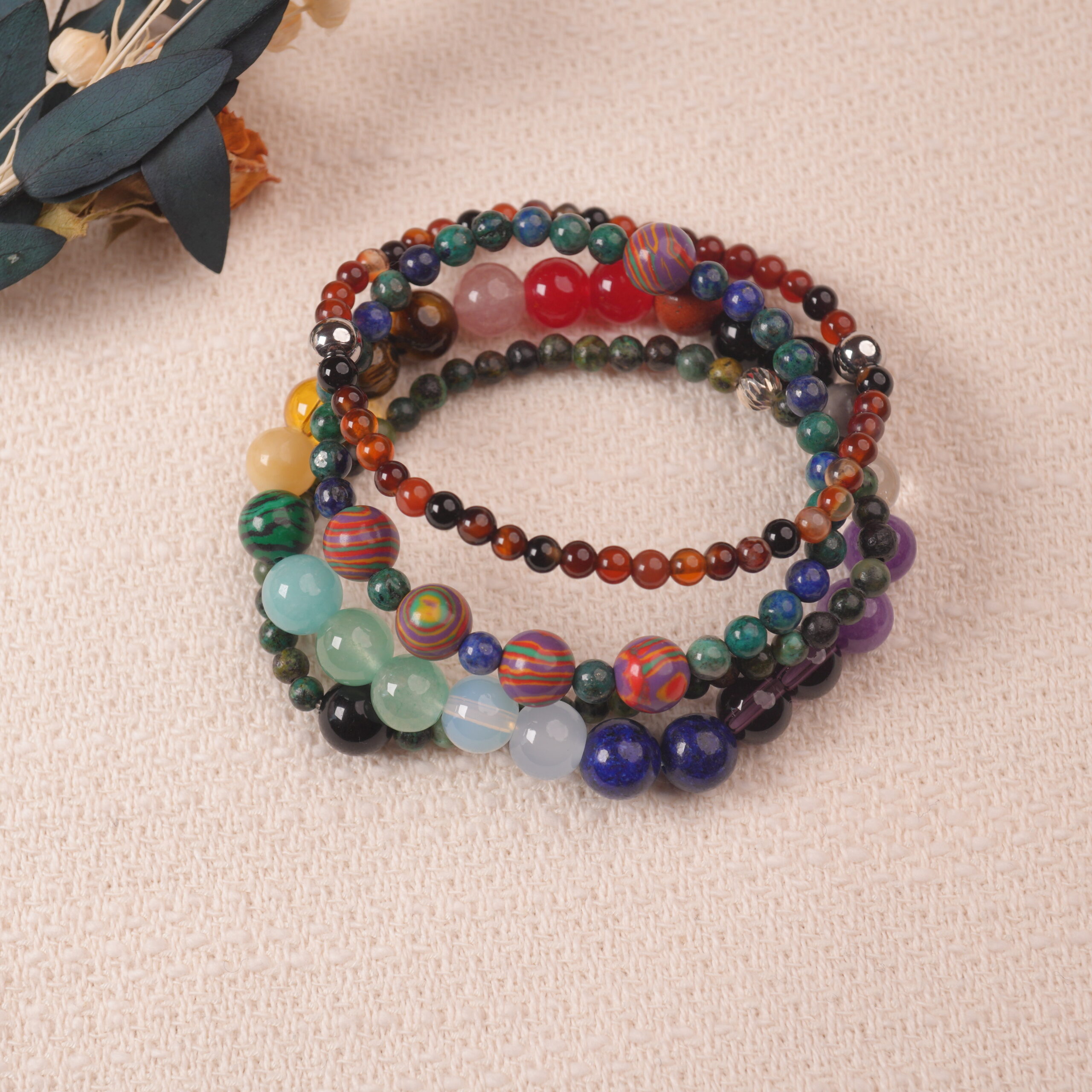 good-luck-multi-gemstone-bracelet-stack-main.jpg Multi-gemstone bracelet stack for good luck, featuring colorful natural crystals arranged in vibrant layers.
