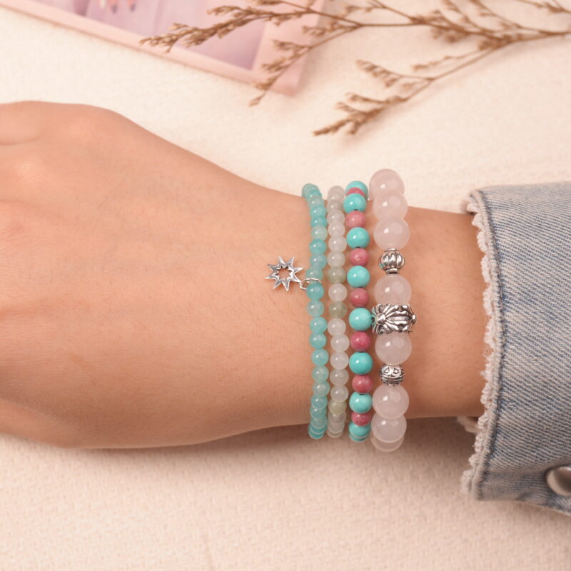 Model wearing the love crystal bracelet stack — a daily reminder of warmth, kindness, and compassion.1