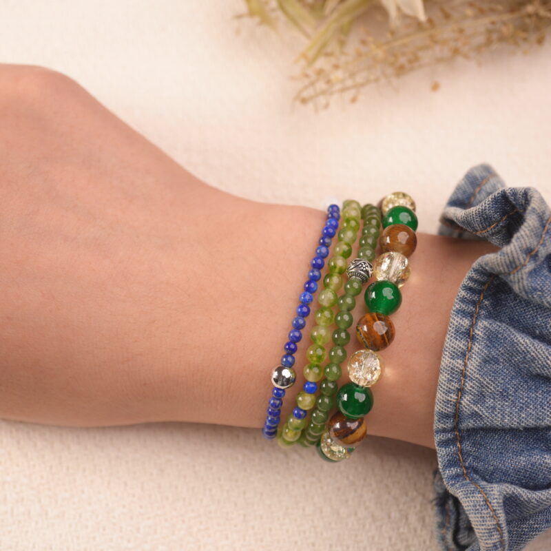 Model wearing the Fortune Grove good luck bracelet stack, expressing joyful energy and fresh opportunities.1