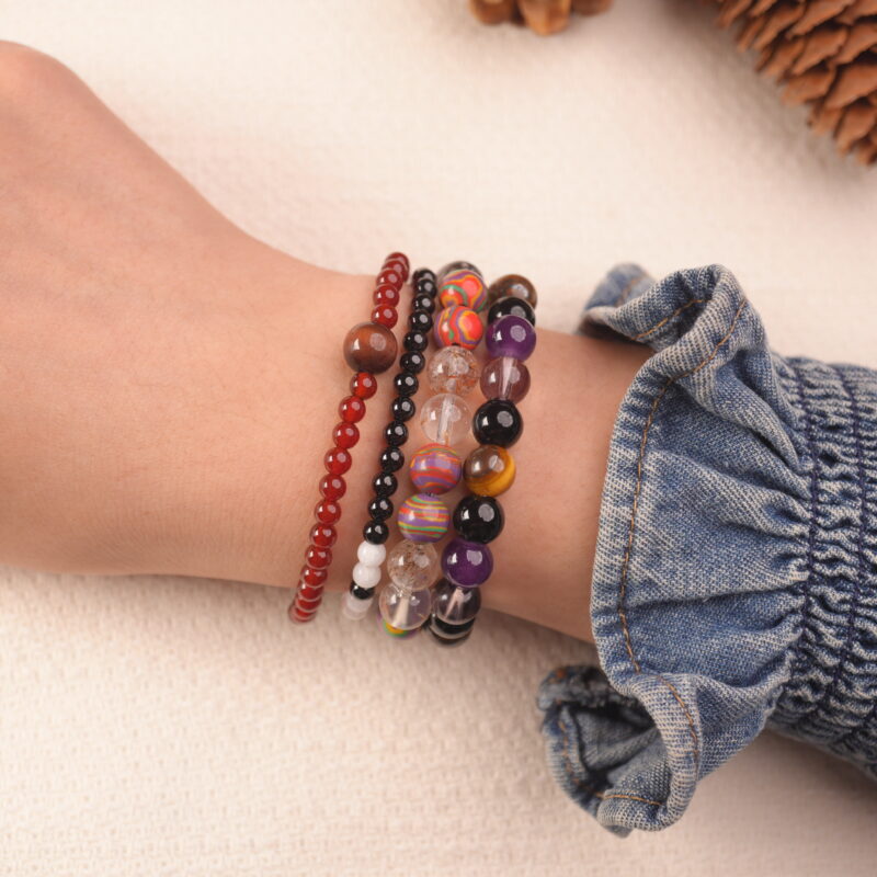 Model wearing the Flame Spirit vitality bracelet stack, radiating energy and fearless charm.1