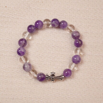 A beautiful bracelet featuring Amethyst and Clear Quartz beads, with a stylish silver cross accent. The smooth, vibrant purple amethyst is complemented by the transparent, calming clear quartz, making this piece perfect for adding balance and tranquility to your collection.