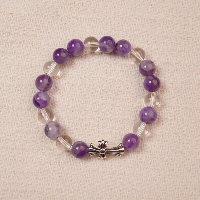 A beautiful bracelet featuring Amethyst and Clear Quartz beads, with a stylish silver cross accent. The smooth, vibrant purple amethyst is complemented by the transparent, calming clear quartz, making this piece perfect for adding balance and tranquility to your collection.