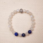 A calming Moonstone and Lapis Lazuli bracelet, featuring smooth, glowing Moonstone beads contrasted with the deep, rich blue of Lapis Lazuli. Finished with a stylish silver accent bead.