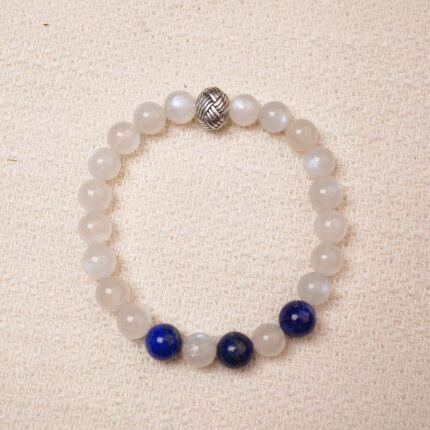 A calming Moonstone and Lapis Lazuli bracelet, featuring smooth, glowing Moonstone beads contrasted with the deep, rich blue of Lapis Lazuli. Finished with a stylish silver accent bead.