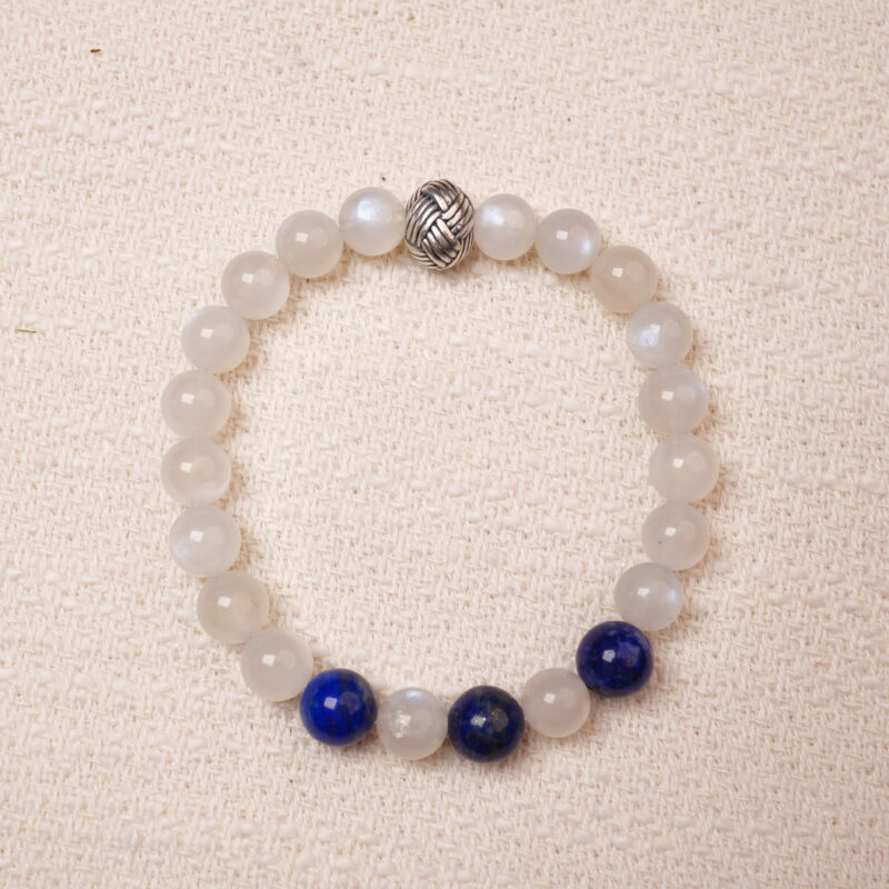 A calming Moonstone and Lapis Lazuli bracelet, featuring smooth, glowing Moonstone beads contrasted with the deep, rich blue of Lapis Lazuli. Finished with a stylish silver accent bead.