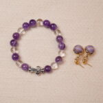 A beautiful combination of Amethyst and Quartz bracelet with a silver knot charm, paired with elegant purple embroidered earrings. This set exudes a sense of calm and balance, perfect for both casual and formal occasions.