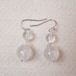 Close-up of the Clear Quartz earrings, showcasing the elegant translucent crystal beads and their sophisticated silver hooks.