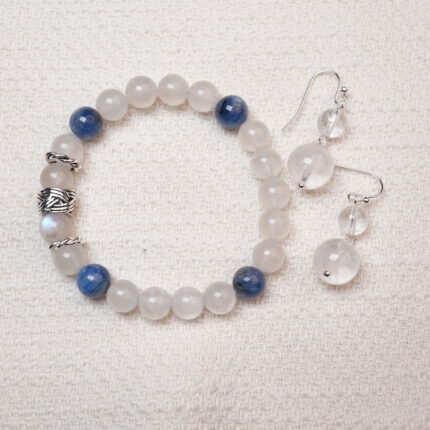 A beautiful set featuring a Moonstone and Kyanite bracelet paired with matching Clear Quartz earrings, designed to bring harmony and tranquility with their elegant energy.