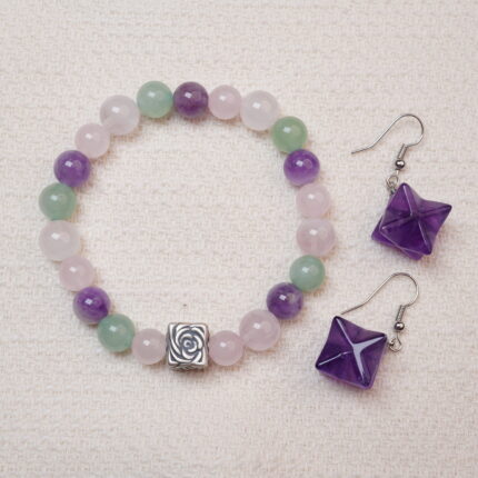 A stunning set featuring a Rose Quartz, Amethyst, and Green Aventurine bracelet, paired with Amethyst Merkaba earrings. The elegant design and soothing energy of both pieces make this set perfect for creating harmony and balance in your style.
