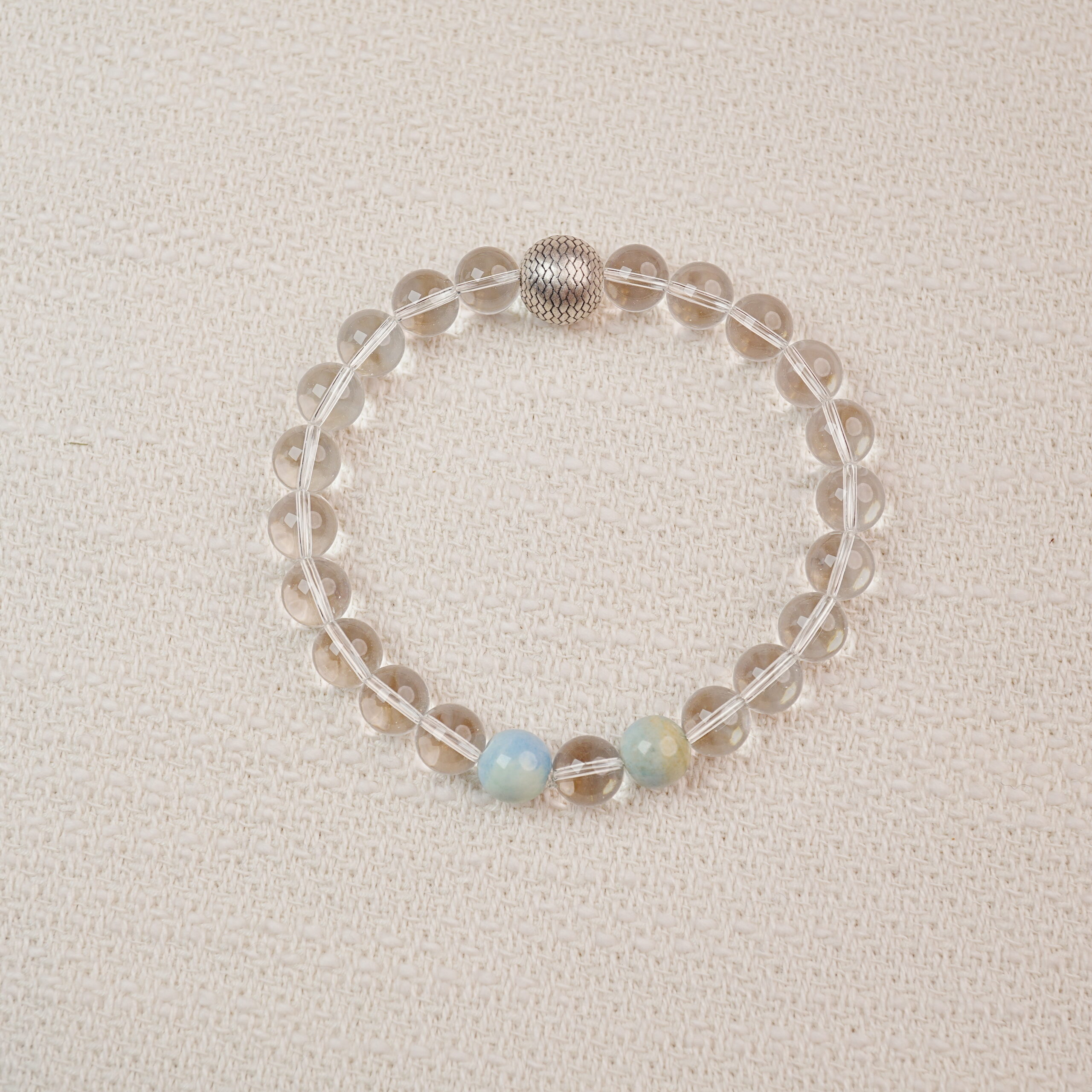 clear-quartz-bracelet-main Clear Quartz beaded bracelet with a textured silver bead – main product image.
