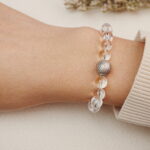 Clear Quartz bracelet worn on wrist with a silver accent bead.