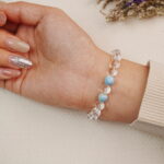 Clear Quartz gemstone bracelet shown on hand, highlighting the natural clarity of the beads.