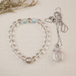 White Crystal & Blue Chalcedony Bracelet and Pendant Set with floral background – Crystal Healing Jewelry – Scene Image