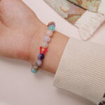Front view of the multi-gemstone bracelet worn on the wrist, highlighting the vibrant mix of natural crystal beads.