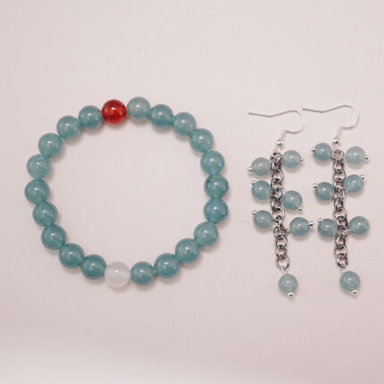 A beautiful set featuring a green chalcedony bracelet with a carnelian accent and matching green chalcedony earrings with a chain design.