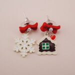 Close-up of Christmas Snowflake Earrings with Red Bow - Detail Image