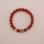 A vibrant Carnelian and Green Chalcedony bracelet featuring rich red Carnelian beads with a touch of green Chalcedony and other calming gemstones in between. Accented with gold spacers, this bracelet is a powerful symbol of vitality and healing energy.