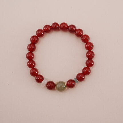 A vibrant Carnelian and Green Chalcedony bracelet featuring rich red Carnelian beads with a touch of green Chalcedony and other calming gemstones in between. Accented with gold spacers, this bracelet is a powerful symbol of vitality and healing energy.