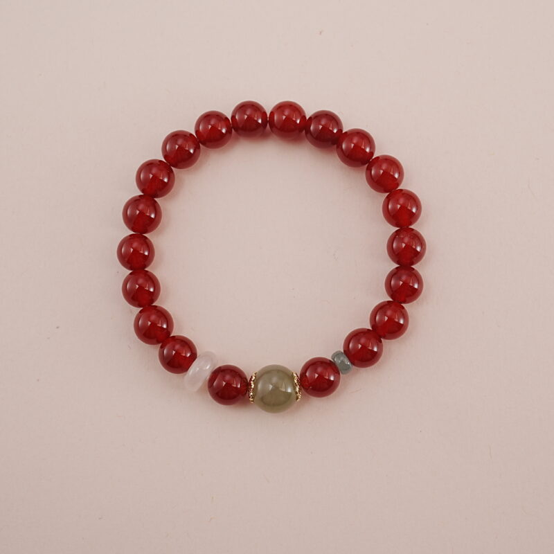 A vibrant Carnelian and Green Chalcedony bracelet featuring rich red Carnelian beads with a touch of green Chalcedony and other calming gemstones in between. Accented with gold spacers, this bracelet is a powerful symbol of vitality and healing energy.