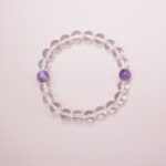 Clear quartz bracelet with two amethyst accent beads – main product image.