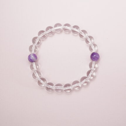 Clear quartz bracelet with two amethyst accent beads – main product image.