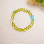 Peridot bracelet styled in a soft and gentle scene setting.