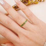 Peridot ring worn on the hand, showing its fresh green sparkle in natural light.