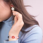 Model Wearing Multi-Gemstone Bracelet with Christmas Snowflake and Red Bow Earrings Set - Wear Image