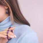 Model wearing the obsidian amethyst bracelet and earrings set, showcasing the jewelry in a natural pose.