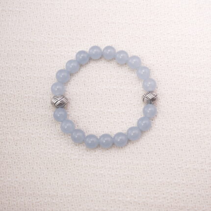 Main image of a bracelet made with smooth aquamarine round beads and two textured silver spacers.