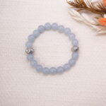 Aquamarine bracelet styled on a textured surface with surrounding natural accents.