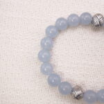 Close-up view of polished aquamarine beads and silver spacers on the bracelet.