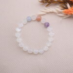 White Moonstone bracelet with pastel gemstone accents displayed with dried flowers.