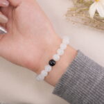 Moonstone bracelet on wrist with the black obsidian focal bead facing upward.