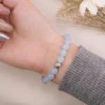 Aquamarine bracelet shown on the palm side of the hand, displaying its gentle blue beads clearly.