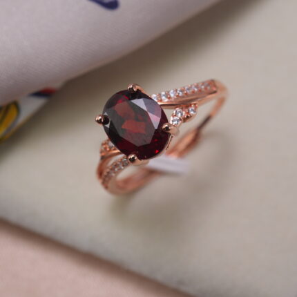 Oval-cut ruby ring in rose gold with side accent stones – main product image