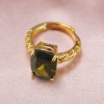 Close-up detail of the peridot ring highlighting its faceted green gemstone.